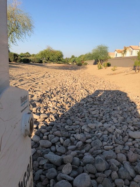 River rock in HOA drainage area