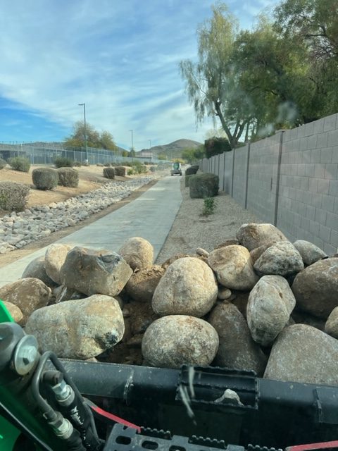 River rock in HOA drainage